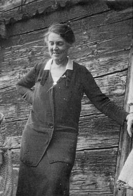 Black and white photo of a middle aged woman wearing a cardigan